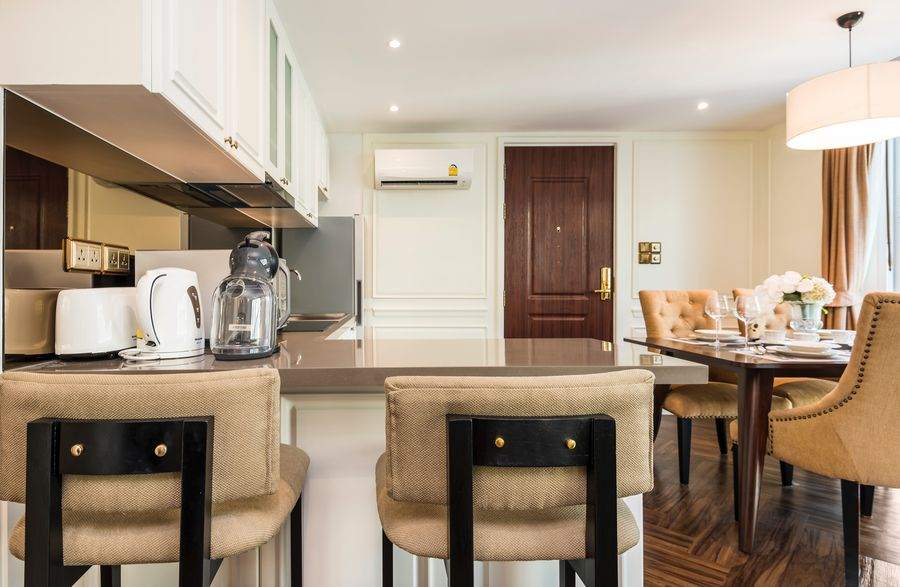 A full kitchen with a breakfast bar in a serviced apartment in Thong Lor, Bangkok
